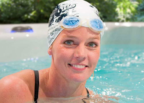 Woman swimming with swim cap in an h2x swimspa